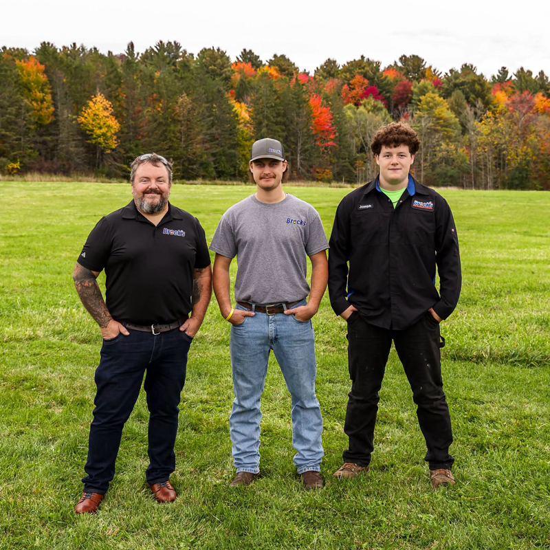 Sean, Noah, and Joseph Brock standing in a field