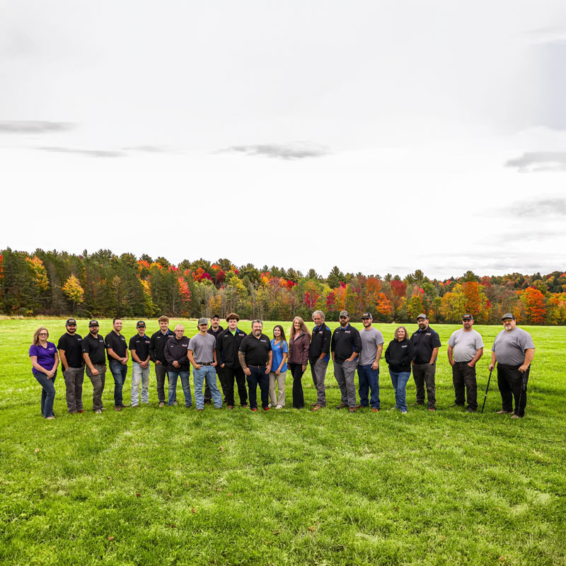 Group shot of the entire Brock's crew with fall trees in the background