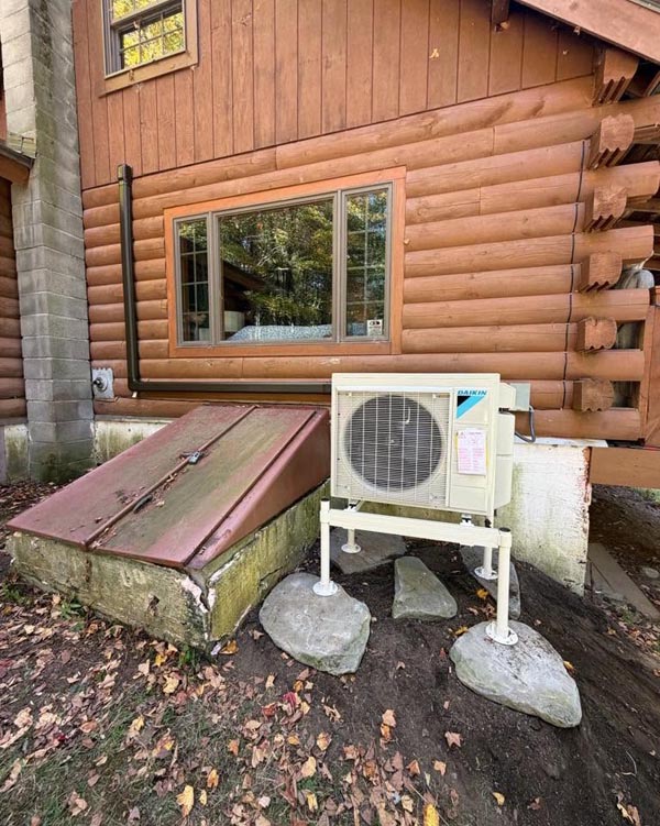 Daikin Outdoor Heat Pump installed outside a log cabin