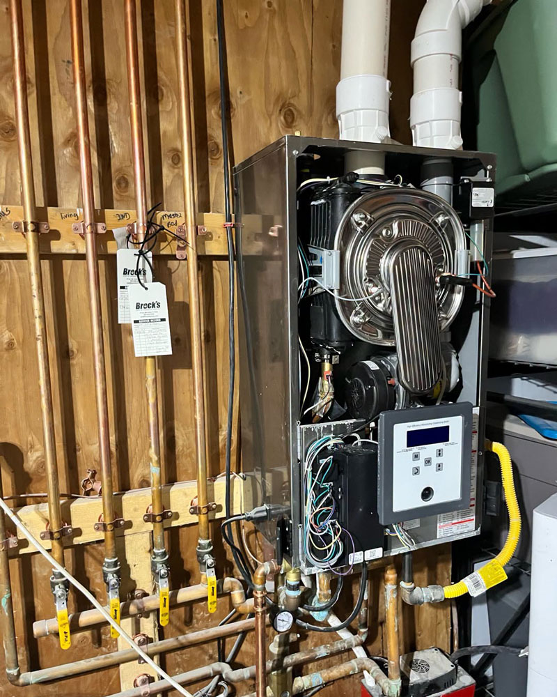 Furnace with the cover off and two Service Tags
