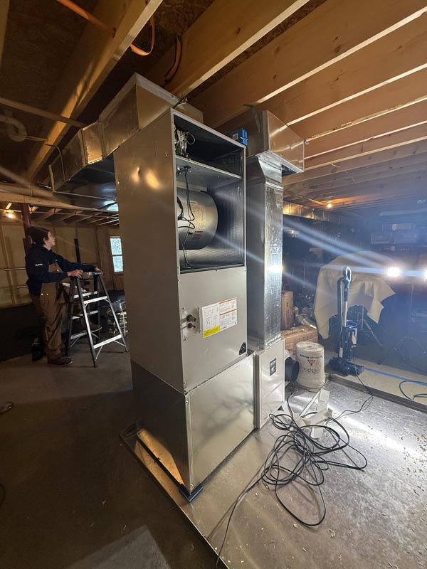 New Bosch air handler and ductwork being installed in a Fairfax basement.