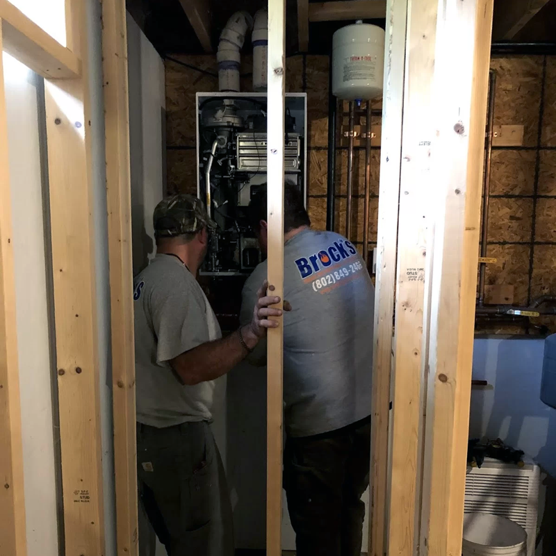 Two Brock Service Techs repairing a furnace