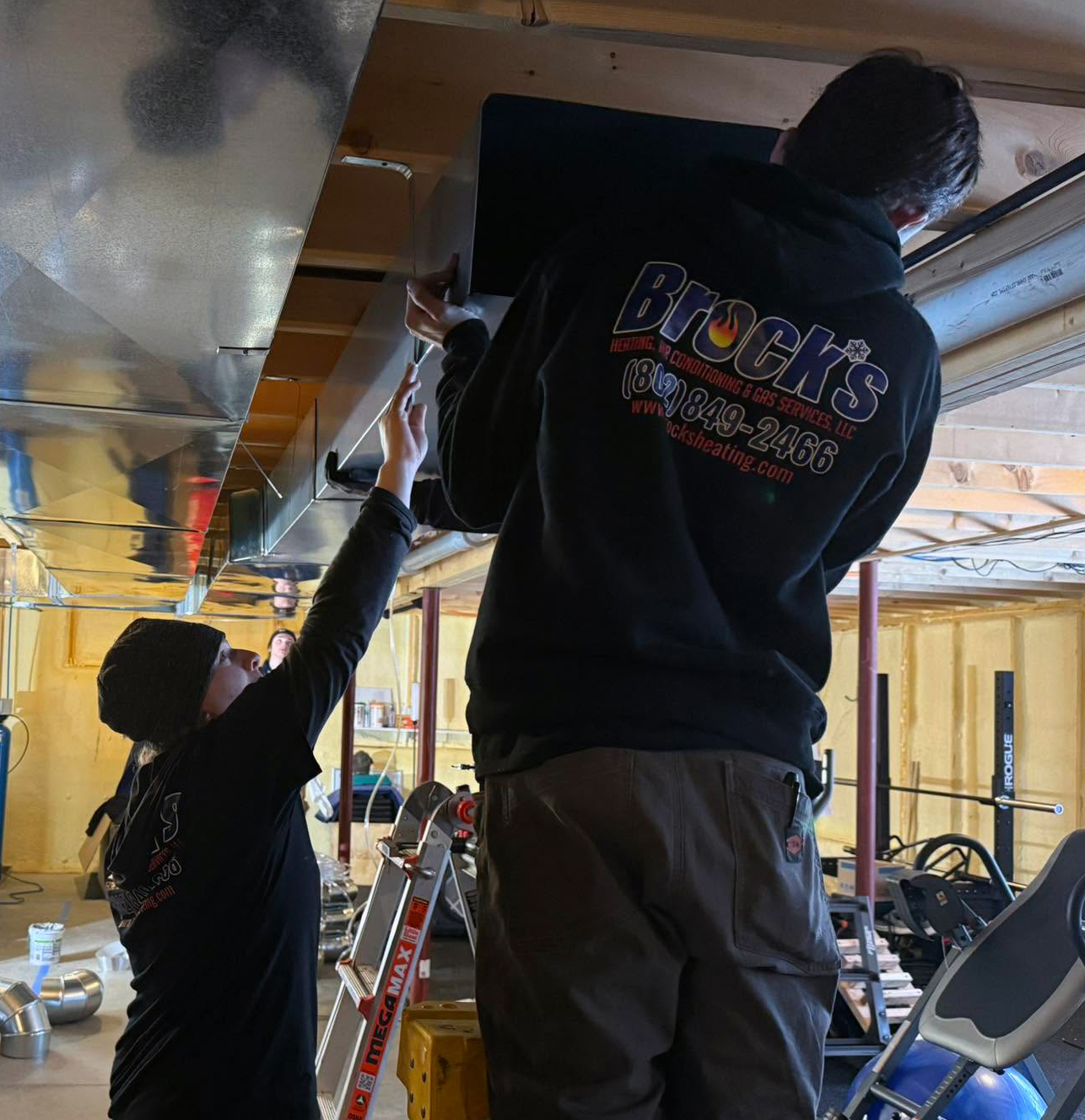 Two Brock's techs working on duct work