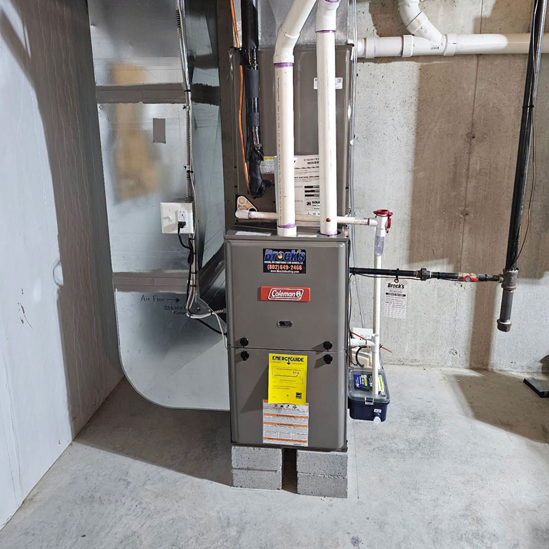 Coleman Furnace on cement blocks in a basement