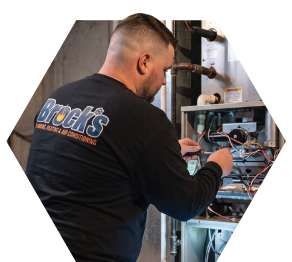 Service tech working on a furnace