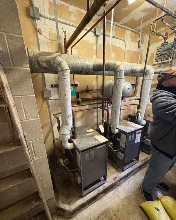 Two old boilers in a church basement