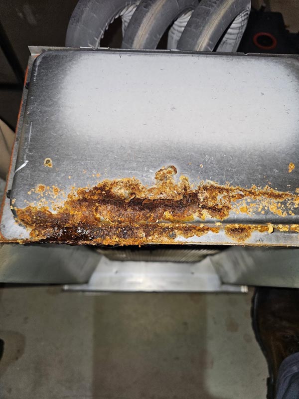 Metal section of a furnace with rust/corrosion